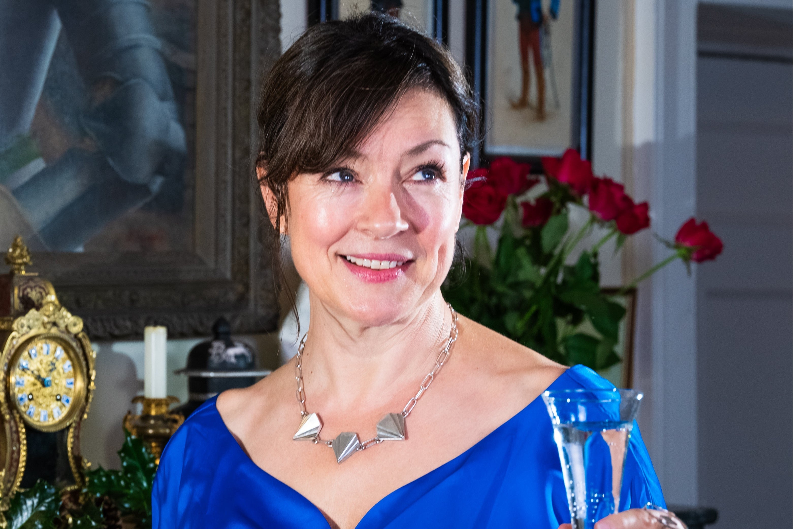 Mum over 50 wearing statement necklace Unity Necklace sterling silver made in Ireland and blue dress