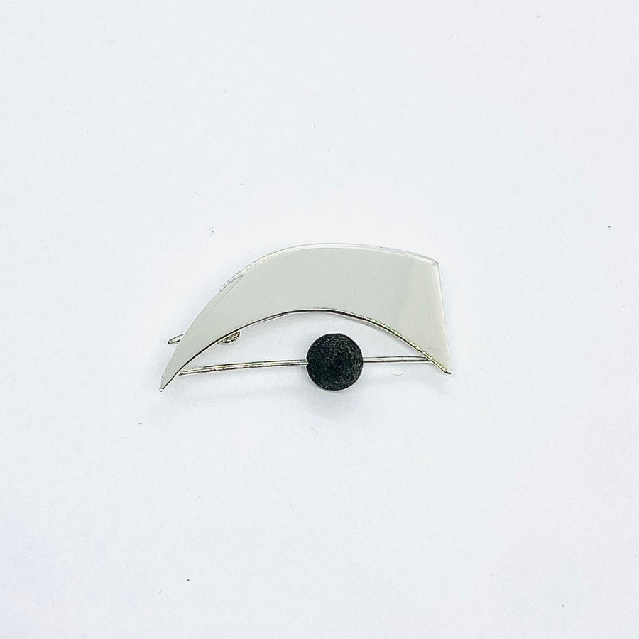 Silver Eye brooch handmade from sterling silver with a lava bead to create an abstract artists piece of jewellery design