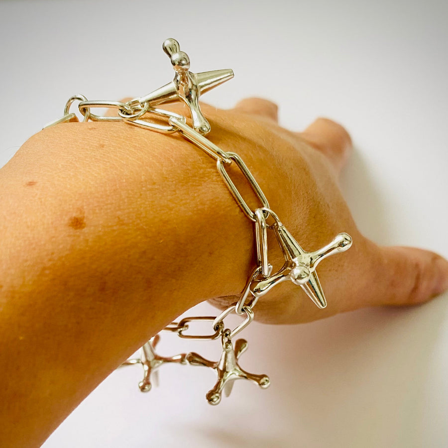 silver chain charm bracelet with four silver ack charms