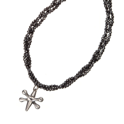 Close up of silver jack pendant withe three strands of sparkling cut black spinel beads made by vanessa ree in ireland