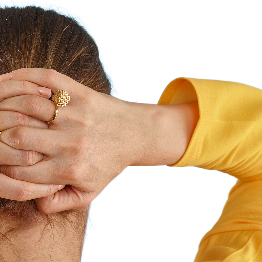 Gold Vermeil airspace ring worn by model hands behind her head