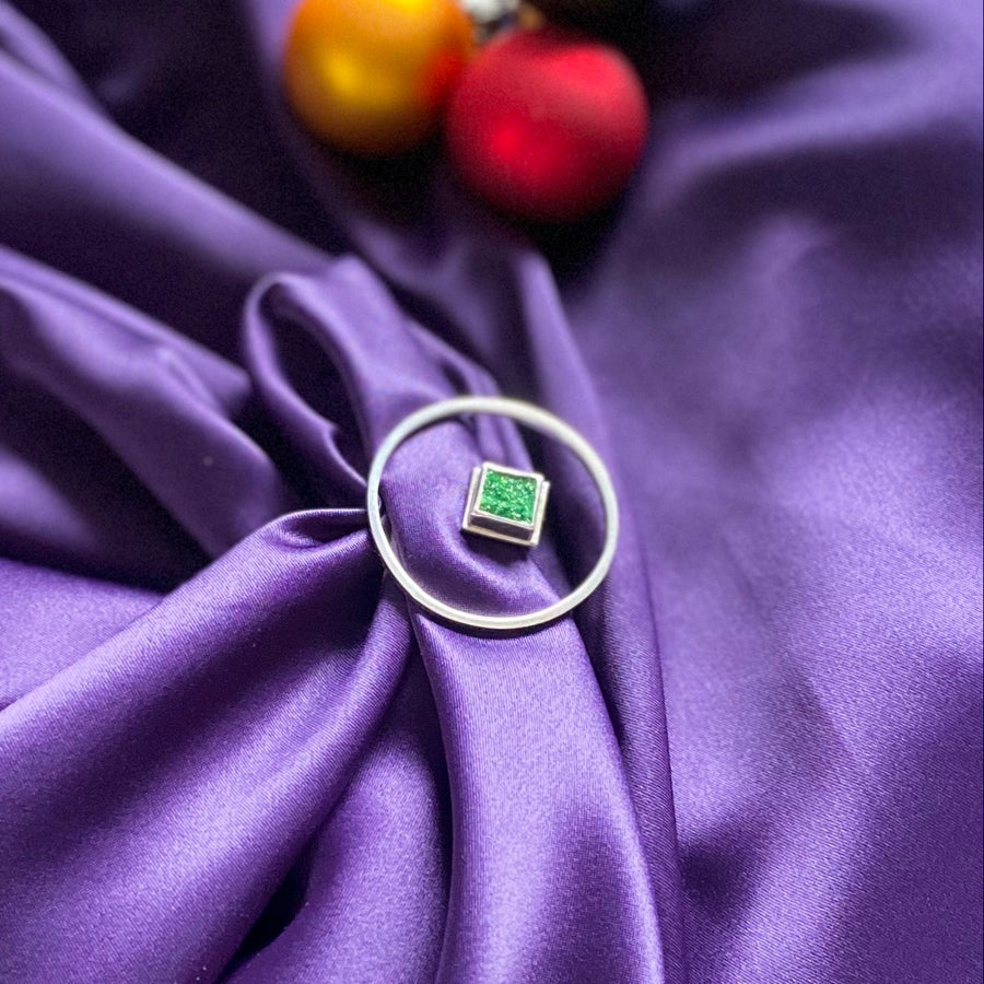 statement hand ring set with green uvarovite in a silver circle frame