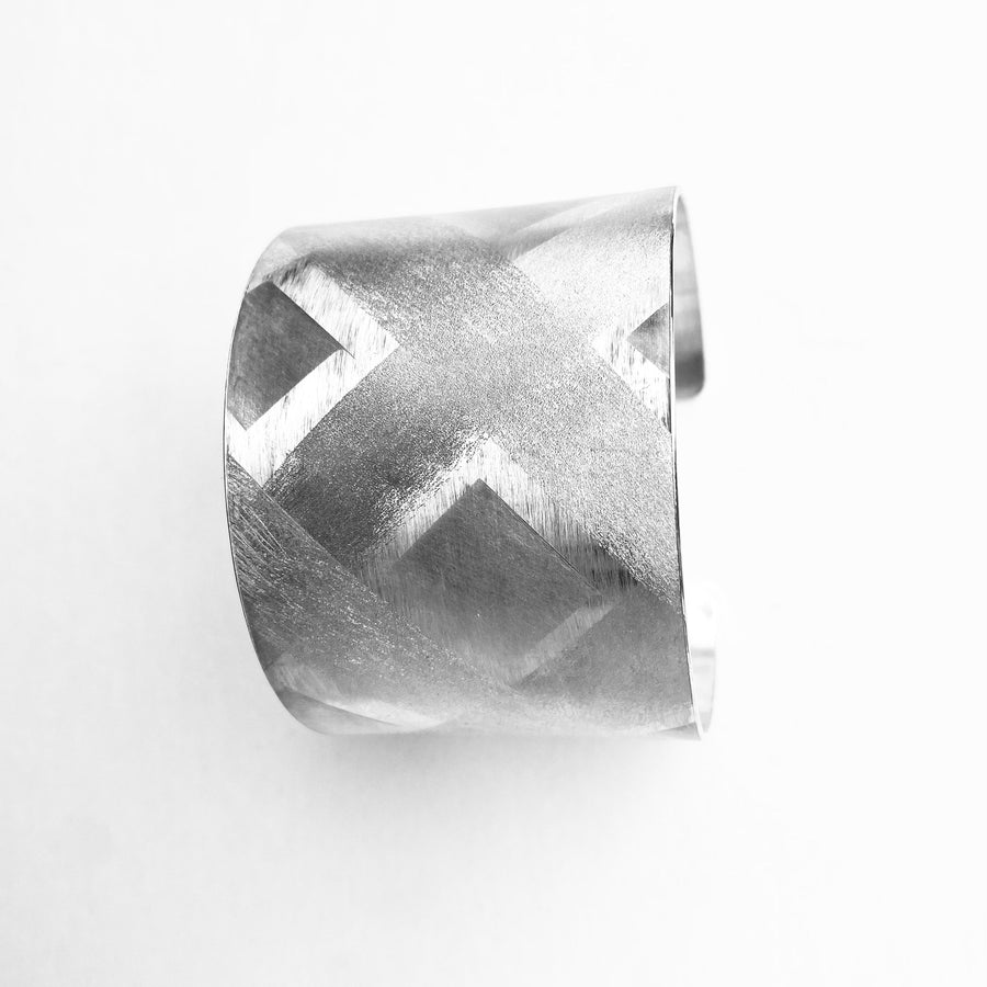 silver arm cuff with textured pattern hand forged in Ireland